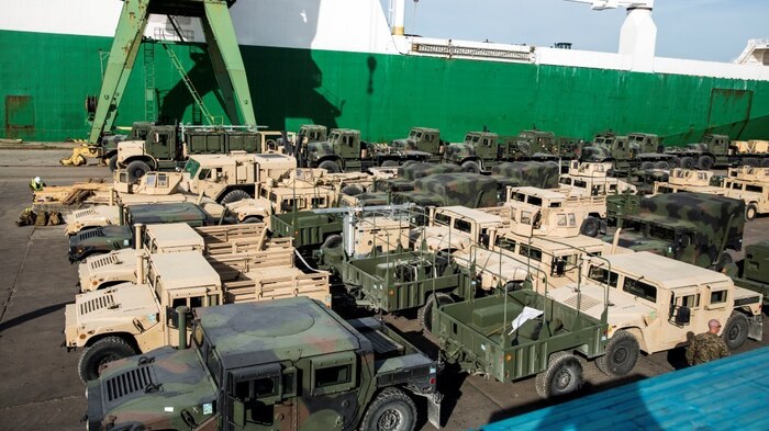 A fleet of military vehicles wait in a staging lot after being offloaded from ship in preparation of Exercise Saber Strike 16 in Riga, Latvia, June 4, 2016. Exercise Saber Strike is an annual combined-joint exercise in the Baltic region. The combined training prepares allies and partners to rapidly amass during regional crises and meet their own security needs by improving the security of borders and countering threats.