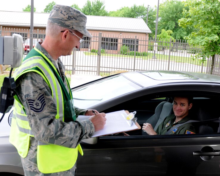 Tech. Sgt. Michael Riggenbach a safety technician with the 910th Airlift Wing safety office, performs a seatbelt check of incoming Service members at the main gate here June 4, 2016. Wing Safety performs this check annually during the National Highway Transportation Safety Administration’s Click it or Ticket initiative held from May 23 to June 6. (U.S. Air Force photo/Tech. Sgt. James Brock)