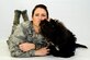 Capt. Carmella Burruss, the 22nd Operations Support Squadron deputy chief of wing intelligence, poses for a photo with Valco on May 25, 2016, at McConnell Air Force Base, Kan. Valco is a Labrador-poodle mix who has been training with Burruss to get his certification from Therapy Dog International so he can work in Veterans Affairs hospitals. (U.S. Air Force photo/Airman 1st Class Jenna K. Caldwell)