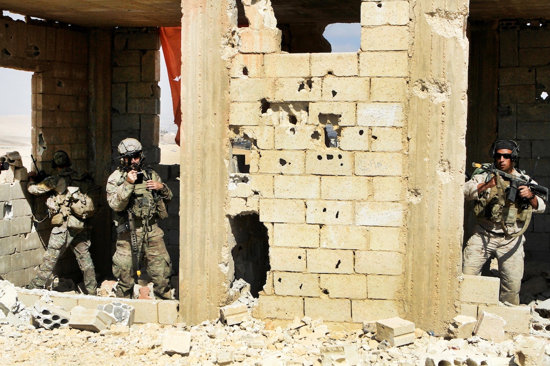 U.S. Army special operations soldiers secure a building and call in a situation report during a simulated raid as part of exercise Eager Lion 2016 in Al Zarqa, Jordan, May 23, 2016. Army photo by Sgt. 1st Class Sean Foley