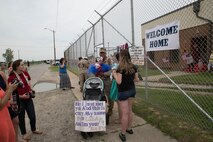 Corporal Joshua Meziere, a grenadier with 5th platoon, Charlie Company, Fleet Anti-Terrorism Team, Marine Corps Security Force Regiment, hugs his daughter for the first time after returning to Camp Allen, Norfolk from a seven-month deployment to Bahrain, June 6, 2016. During their deployment, the Marines conducted security operations in the United States Fifth Fleet area of operations, while training alongside other forces in Bahrain, Kuwait, Qatar and Jordan. Along with providing support for their mission, the Marines engaged in training evolutions such as fire team competitions, professional military education and weapon system ranges. (Official Marine Corps photo by Cpl. Calvin Shamoon/ Released)