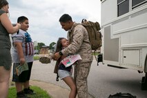 Staff Sgt. Jose Hernandez , platoon Sgt. for 5th platoon, Charlie Company, Fleet Anti-Terrorism Team, Marine Corps Security Force Regiment, hugs his daughter and greets his family after returning to Camp Allen, Norfolk from a seven-month deployment to Bahrain, June 6, 2016. During their deployment, the Marines conducted security operations in the United States Fifth Fleet area of operations, while training alongside other forces in Bahrain, Kuwait, Qatar and Jordan. Along with providing support for their mission, the Marines engaged in training evolutions such as fire team competitions, professional military education and weapon system ranges. (Official Marine Corps photo by Cpl. Calvin Shamoon/ Released)