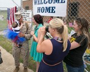 Corporal Joshua Meziere, a grenadier with 5th platoon, Charlie Company, Fleet Anti-Terrorism Team, Marine Corps Security Force Regiment, hugs his daughter for the first time after returning to Camp Allen, Norfolk from a seven-month deployment to Bahrain, June 6, 2016. During their deployment, the Marines conducted security operations in the United States Fifth Fleet area of operations, while training alongside other forces in Bahrain, Kuwait, Qatar and Jordan. Along with providing support for their mission, the Marines engaged in training evolutions such as fire team competitions, professional military education and weapon system ranges. (Official Marine Corps photo by Cpl. Calvin Shamoon/ Released)
