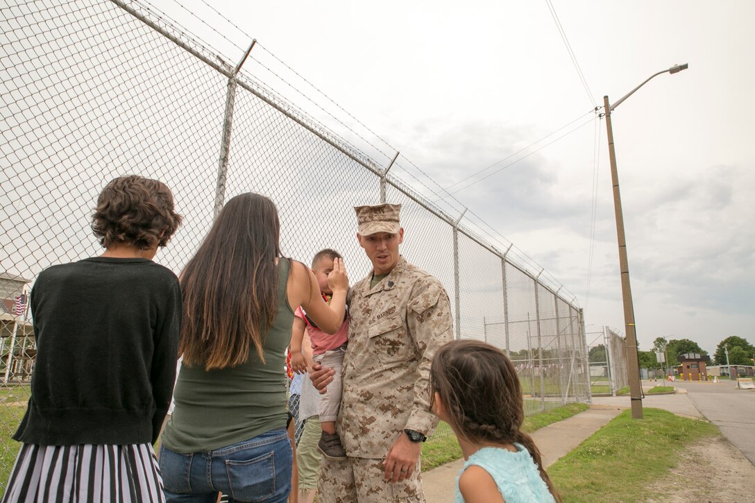 Staff Sgt. Kyle Smail, platoon guide for 5th platoon, Charlie Company, Fleet Anti-Terrorism Team, Marine Corps Security Force Regiment, greets his family after returning to Camp Allen, Norfolk from a seven-month deployment to Bahrain, June 6, 2016. During their deployment, the Marines conducted security operations in the United States Fifth Fleet area of operations, while training alongside other forces in Bahrain, Kuwait, Qatar and Jordan. Along with providing support for their mission, the Marines engaged in training evolutions such as fire team competitions, professional military education and weapon system ranges. (Official Marine Corps photo by Cpl. Calvin Shamoon/ Released)