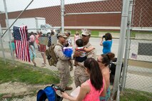 Corporal Joshua Meziere (left) and Sgt. Carlos Garcia, members of 5th platoon, Charlie Company, Fleet Anti-Terrorism Team, Marine Corps Security Force Regiment, hold their children after returning to Camp Allen, Norfolk from a seven-month deployment to Bahrain, June 6, 2016. During their deployment, the Marines conducted security operations in the United States Fifth Fleet area of operations, while training alongside other forces in Bahrain, Kuwait, Qatar and Jordan. Along with providing support for their mission, the Marines engaged in training evolutions such as fire team competitions, professional military education and weapon system ranges. (Official Marine Corps photo by Cpl. Calvin Shamoon/ Released)