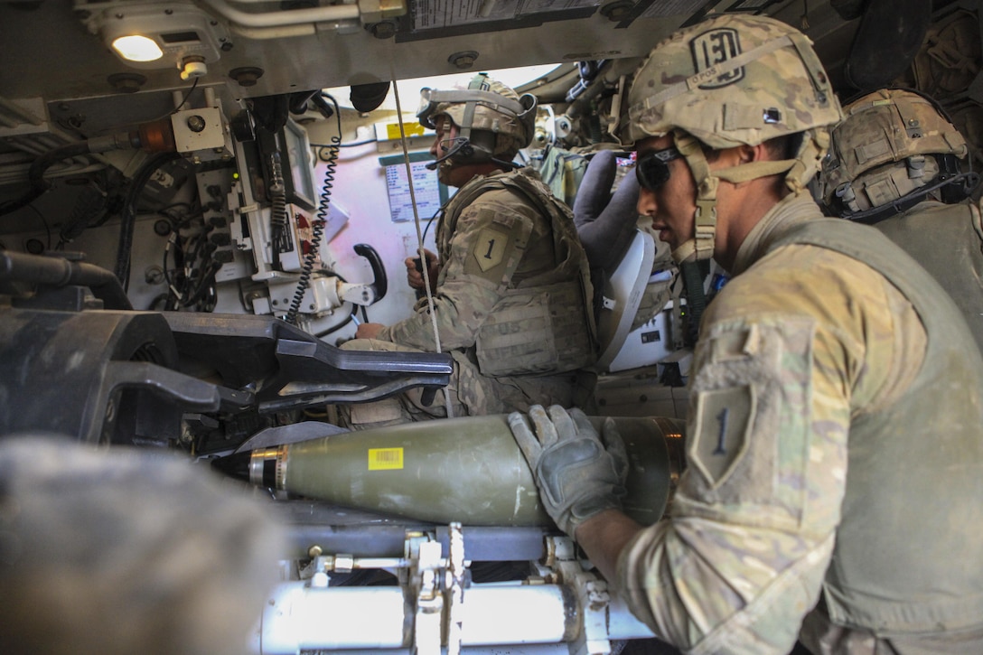 U.S. Army Spc. Marcos Ruiz III, foreground, loads an artillery round into the chamber of a Paladin M109 Alpha-6 howitzer during exercise Eager Lion 2016 at Al Zarqa, Jordan, May 24, 2016. Ruiz is assigned to the 1st Infantry Division’s 1st Infantry Battalion, 7th Field Artillery Regiment. Army photo by Spc. Kevin Kim