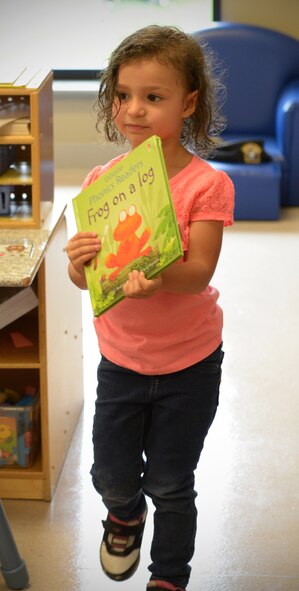 A preschool child picks out her favorite book for story time at Barksdale Air Force Base, La., June 6, 2016. Each quarter, Barksdale’s Child Development Center hosts story time, where Airmen from across the base take time out of their day to read to preschool children. (U.S. Air Force photo/Senior Airman Curt Beach)