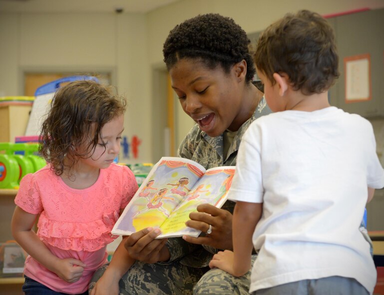 Senior Airman Christina Douglas-Williams, 2nd Security Forces Squadron plans and programs clerk, reads “Ice-Cold Birthday” to preschool children at Barksdale Air Force Base, La., June 6, 2016. Douglas-Williams was one of 40 Airmen who volunteered to take time out of their day to read to preschoolers at Barksdale’s Child Development Center during the week-long event. (U.S. Air Force photo/Senior Airman Curt Beach)