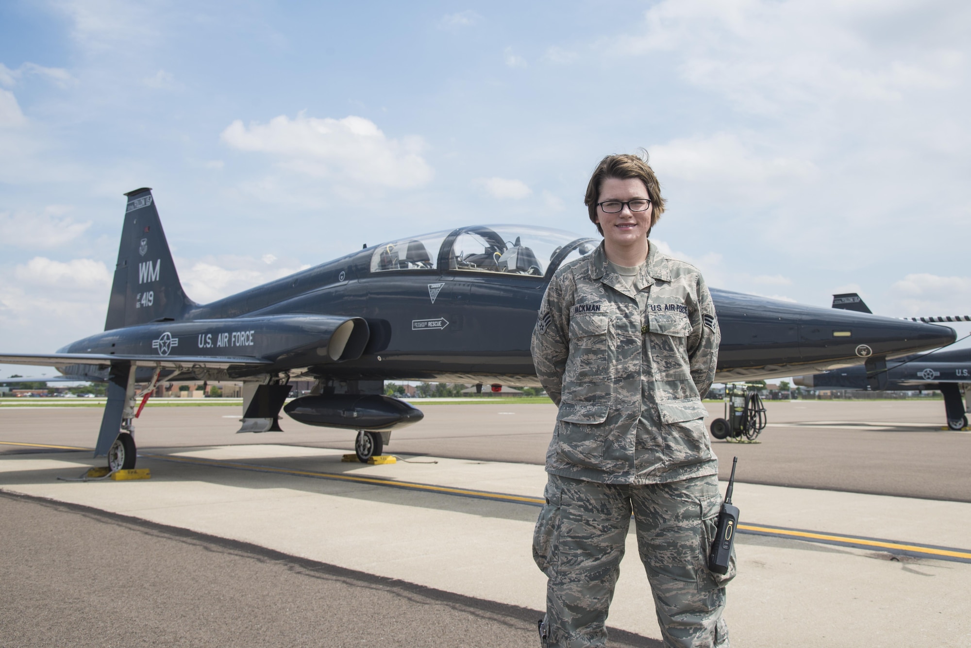 Senior Airman Laura Hackman, 375th Operational Support Squadron airfield managament shift leader, stands in front of a Northrop T-38 Talon Trainer on the air field at Scott Air Force Base, Illinois on May 24, 2016. Airfield management is responsible for ensuring the safety of aircraft landing and depoarting runways by inspecting the airfield, coordinating necessary repairs and responding to airfield emergencies. (U.S. Air Force Photo by Airman Daniel Garcia)