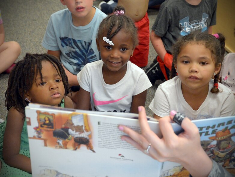 Preschool children listen to the story of “The Three Little Javelinas” during story time at Barksdale Air Force Base, La., June 6, 2016. Each quarter, Barksdale’s Child Development Center hosts story time, where Airmen from across the base take time out of their day to read to preschool children. (U.S. Air Force photo/Senior Airman Curt Beach)