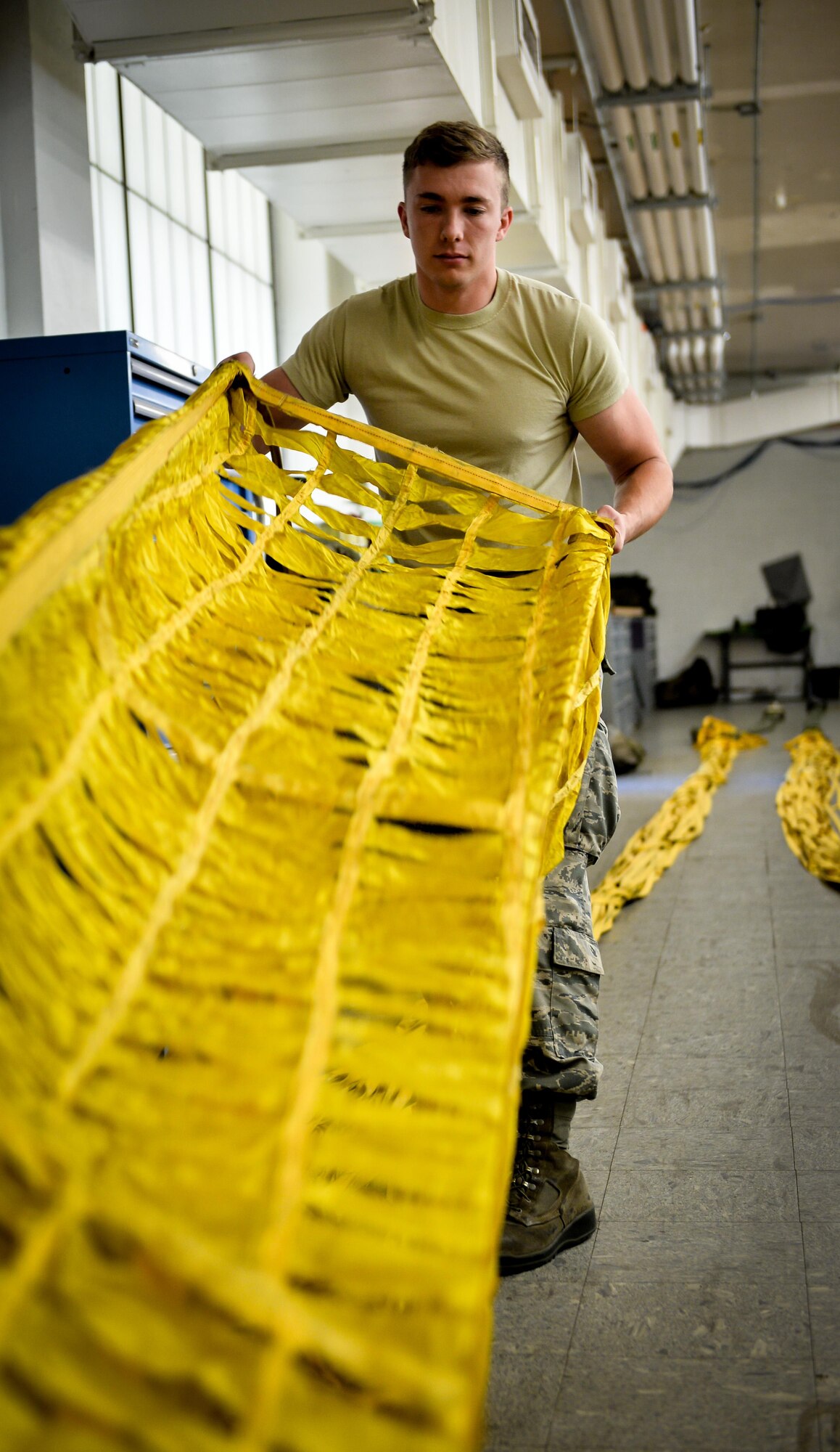 Airman 1st Class Eric Hornbeck, 2nd Operations Support Squadron aircrew flight equipment apprentice, inspects a drag chute at Barksdale Air Force Base, La., June 7, 2016. Hornbeck inspected the canopy and looked for damage that could potentially cause the parachute to malfunction. (U.S. Air Force photo/Senior Airman Mozer O. Da Cunha)