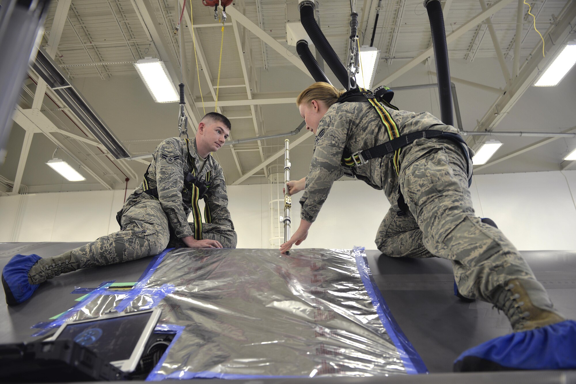 (Right) Airman Samantha Schmedeke, 33rd Maintenance Squadron fuel systems journeyman, demonstrates the proper use of a probe to (Left) Airman 1st Class William Manion, 33rd MXS fuel systems apprentice, at Eglin Air Force Base, Fla., May 16, 2016.  The probe is used to check the fuel levels of an F-35A Lightning II after flight. (U.S. Air Force photo/Senior Airman Andrea Posey)