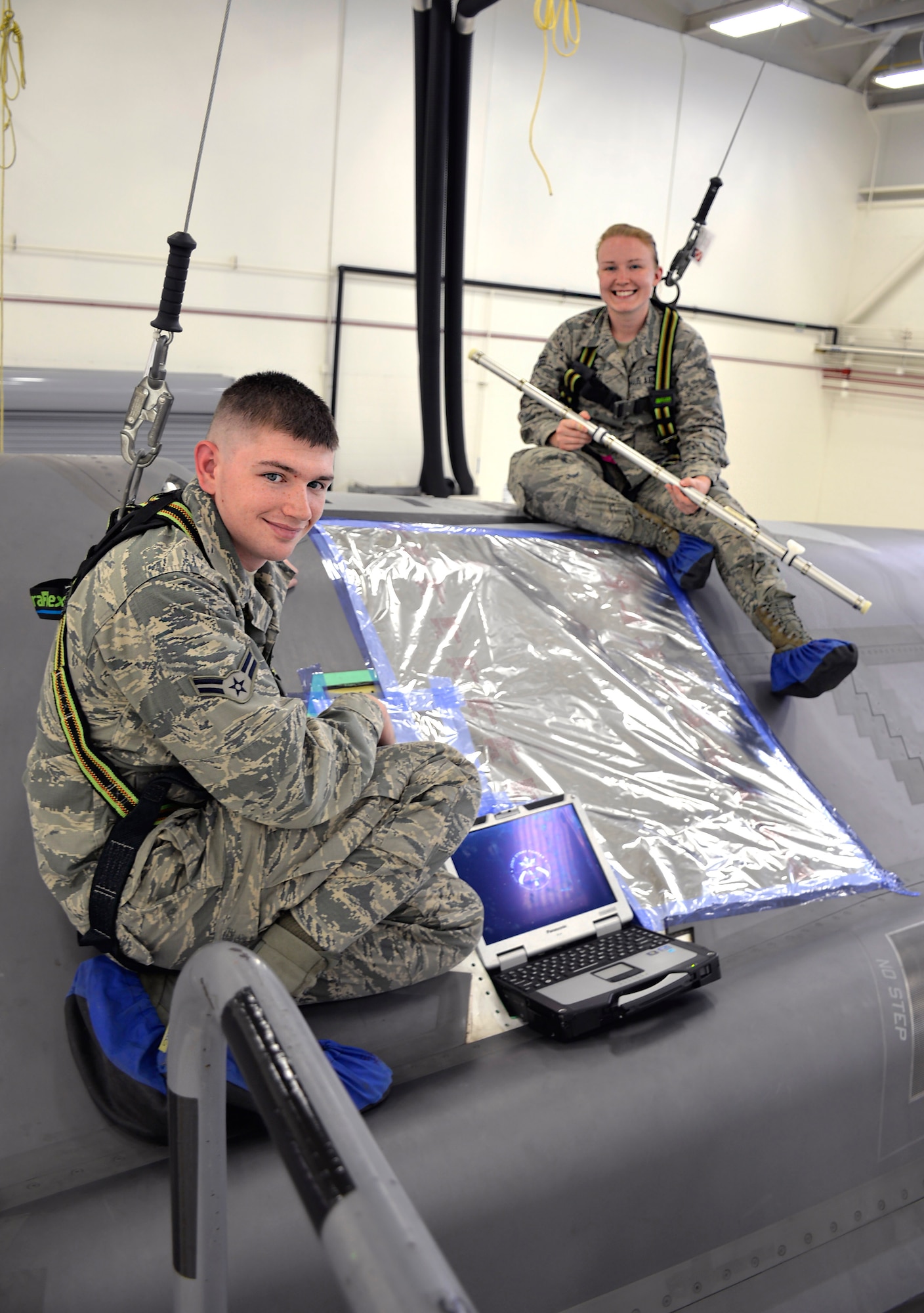 Airman 1st Class William Manion, 33rd Maintenance Squadron fuel systems apprentice, and Airman Samantha Schmedeke, 33rd MXS fuel systems journeyman, conduct maintenance on an F-35A Lightning II at Eglin Air Force Base, Fla., May 16, 2016. Both Airmen are responsible for troubleshooting and correcting issues affecting the fuel systems in the fighter. (U.S. Air Force photo/Senior Airman Andrea Posey)