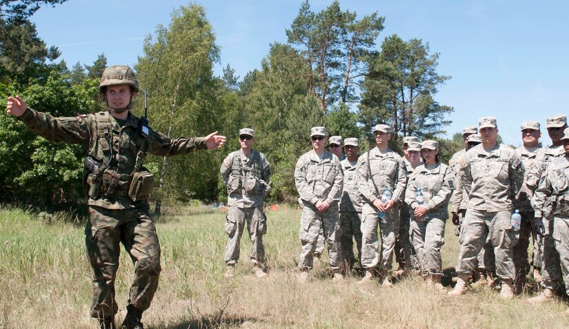 2nd Lt. Damian Stepien, of the 5th Chemical Regiment in the Polish Army, out of Tarnowskie Gory, demonstrates his equipment to U.S. Army Soldiers, from the 44th Chemical Battalion of the Illinois National Gaurd, during Exercise Anakonda 2016, a Polish-led, multinational exercise running from June 7-17. (U.S. Army photo by Spc. Miguel Alvarez/ Released)