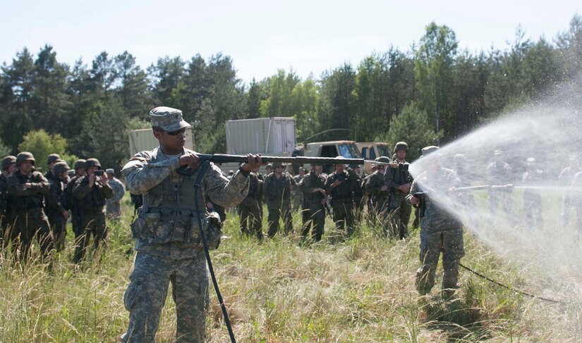 Spc. Frank Gully, a Chemical Operations Specialist, from the 44th Chemical Battalion of the Illinois National Guard, demonstrates his unit's equipment to Polish Soldiers, from the 5th Chemical Regiment, during Exercise Anakonda 2016, a Polish-led, multinational exercise running from June 7-17. (U.S. Army photo by Spc. Miguel Alvarez/ Released)