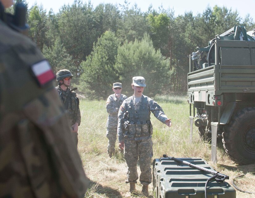 Spc. Callie Coyle, a Chemical Operations Specialist, from the 44th Chemical Battalion of the Illinois National Guard, demonstrates her unit's equipment to Polish Soldiers, from the 5th Chemical Regiment, during Exercise Anakonda 2016, a Polish-led, multinational exercise running from June 7-17. (U.S. Army photo by Spc. Miguel Alvarez/ Released)