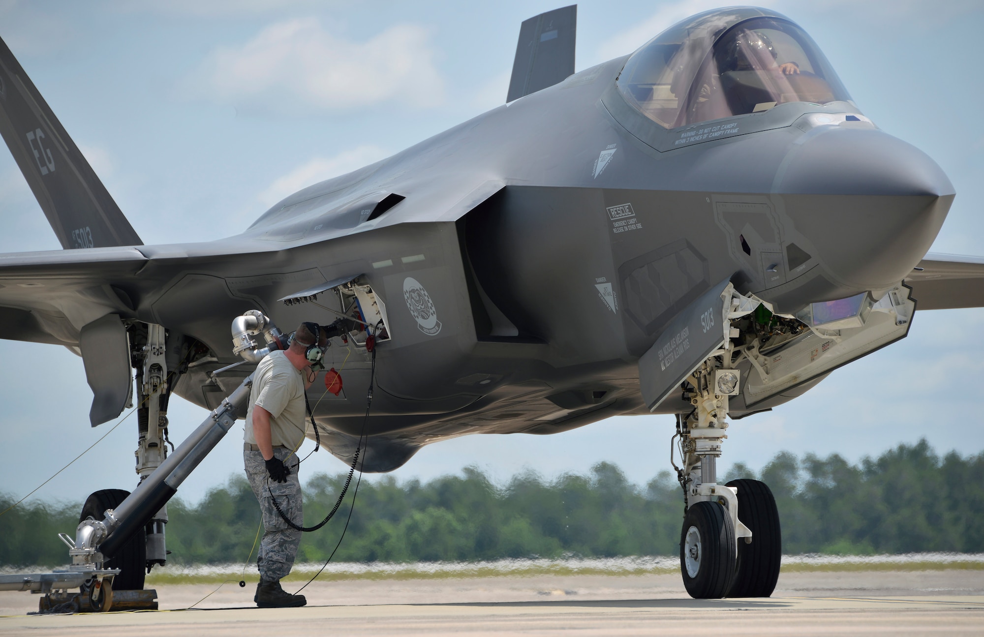 Senior Airman Max Todd, 33rd Aircraft Maintenance Squadron crew chief, performs a hot pit refuel on an F-35A Lightning II at Eglin Air Force Base, Fla., May 13, 2016. This type of aircraft refueling is done while the engine is running to get jets back in the air more quickly and is a common practice during wartime. Crew chiefs from the 33rd Fighter Wing perform this type of refueling at least once a week to keep maintenance Airmen up-to-date on training and qualifications. (U.S. Air Force photo/Senior Airman Andrea Posey)