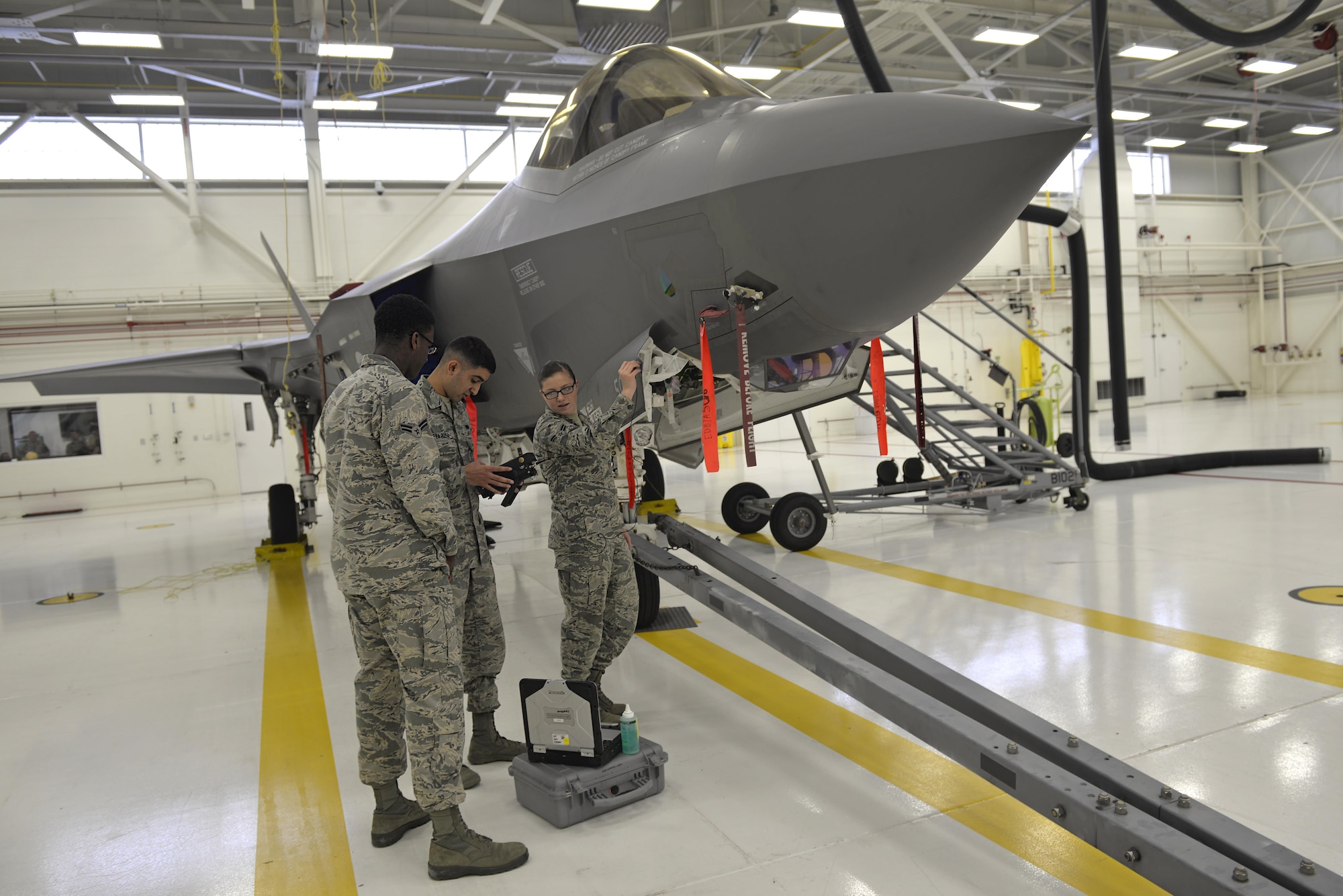 Nondestructive inspection Airmen inspect an F-35A Lightning II panel at Eglin Air Force Base, Fla., May 16, 2016. These specialists are responsible for inspecting the inner layers of metal objects to identify possible defects. The nondestructive inspection section utilizes non-invasive equipment such as transducers, x-rays and ultrasound machines to look for imperfections in the inner layers of metal on an aircraft to preserve the stealth of the aircraft. (U.S. Air Force photo/Senior Airman Andrea Posey)