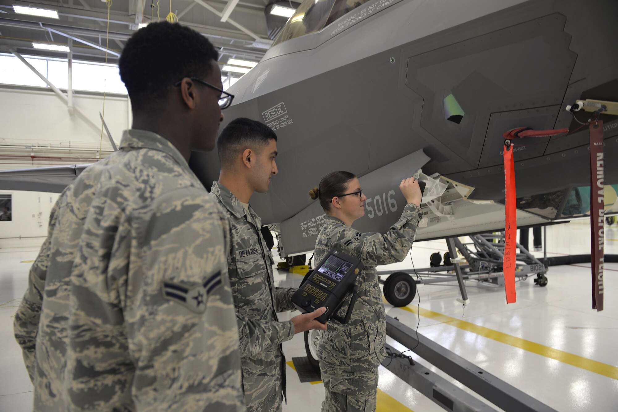 Nondestructive inspection Airmen use a transducer to check for imperfections on an F-35A Lightning II panel at Eglin Air Force base Fla., May 16, 2016. This piece of equipment uses sound vibrations to check for cracks in the inner layers of metal on a jet that may go unnoticed by the naked eye. If there is underlying damage, the Sonic 1200 unit will reflect the depth of damage in need of repair. (U.S. Air Force photo/Senior Airman Andrea Posey)