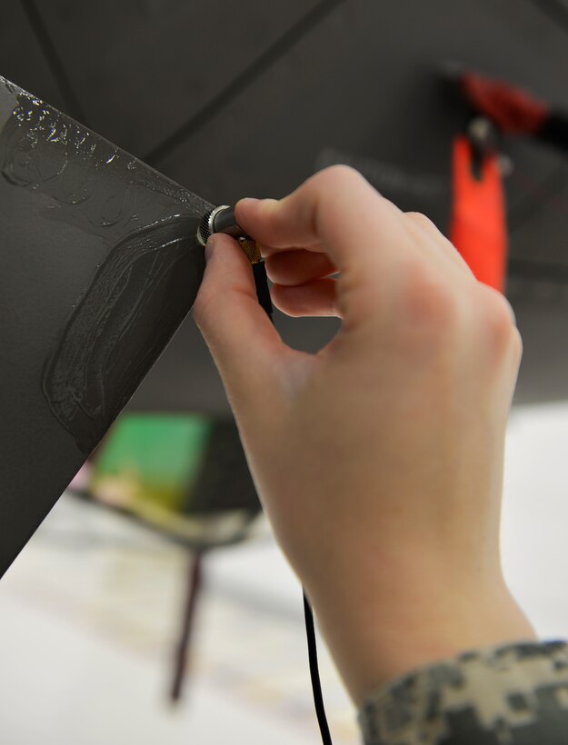 Airman 1st Class Emily Greaves, 33rd Maintenance Squadron nondestructive inspection apprentice, uses a transducer to check for cracks in the low observable paint on an F-35A Lightning II at Eglin Air Force Base Fla., May 17, 2016. The transducer picks up clear sound vibrations to identify any underlying cracks that would diminish the stealth capability of the aircraft. The transducer sends the readings to the Sonic 1200 which reveals the depth of damage inside the metal of an aircraft. (U.S. Air Force photo/Senior Airman Andrea Posey)