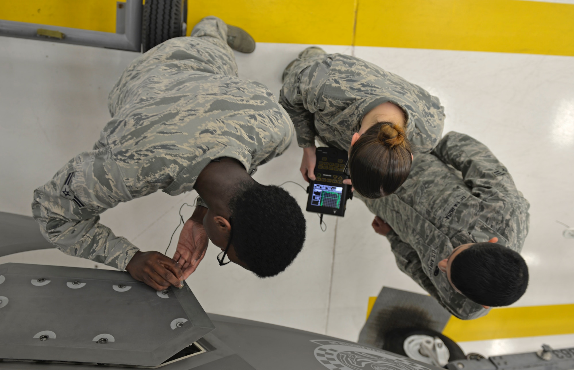 Nondestructive inspection Airmen check an F-35A Lightning II panel for wear and tear at Eglin Air Force Base Fla., May 16, 2016. These specialists use a transducer and a Sonic 1200 to inspect the inner layers of metal objects for metal fatigue resulting from the daily function of jets. The transducer creates sound vibrations and sends the readings to the Sonic 1200 to reveal the depth of damage inside the metal of an aircraft. (U.S. Air Force photo/Senior Airman Andrea Posey)