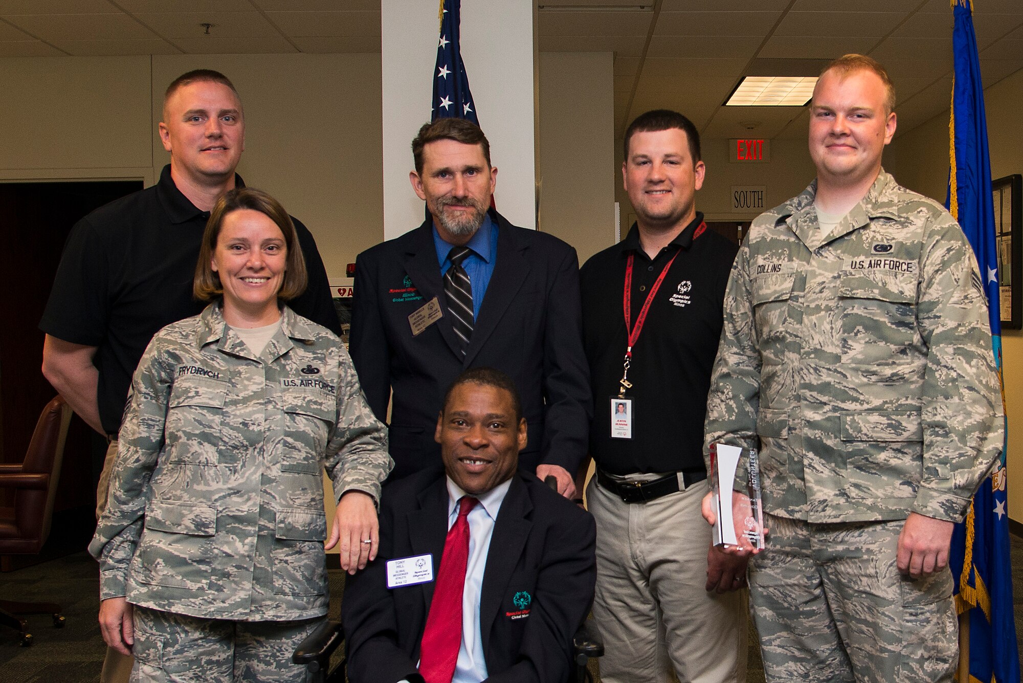 Master Sgt. Jule Frydrych and Senior Airman Tanner Collins were presented with Illinois Special Olympics Area 12 Volunteer of the Year awards at a ceremony May 25, 2016. The award is presented annually to individuals who exhibit exceptional effort while working with Illinois Special Olympics. Front row (from left to right), Frydrych and Tony Hill; back row (from left to right), Steve Whitlach, Tony Nihles, Justin Dunning and Collins. (Photo by Airman 1st Class Gwendalyn Smith)