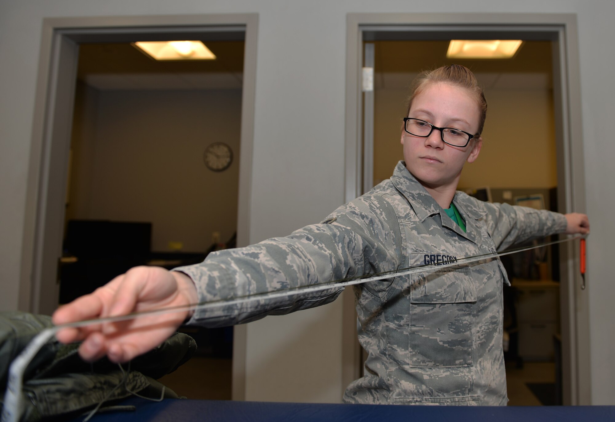 Senior Airman Sean Gregory, 33rd Operations Support Squadron aircrew flight equipment technician, measures a hook blade knife lanyard at Eglin Air Force Base, Fla., Feb. 29, 2016. The knife is worn by pilots as a safety precaution. Should they need to egress from the aircraft for any reason the knife would be used to cut the parachute lines. Flight equipment technicians at the 33rd Fighter Wing have been responsible for over 241 action reports used across the program for the maintenance of F-35 flight equipment and are responsible for providing pilots reliable equipment. (U.S. Air Force photo/Senior Airman Andrea Posey) 