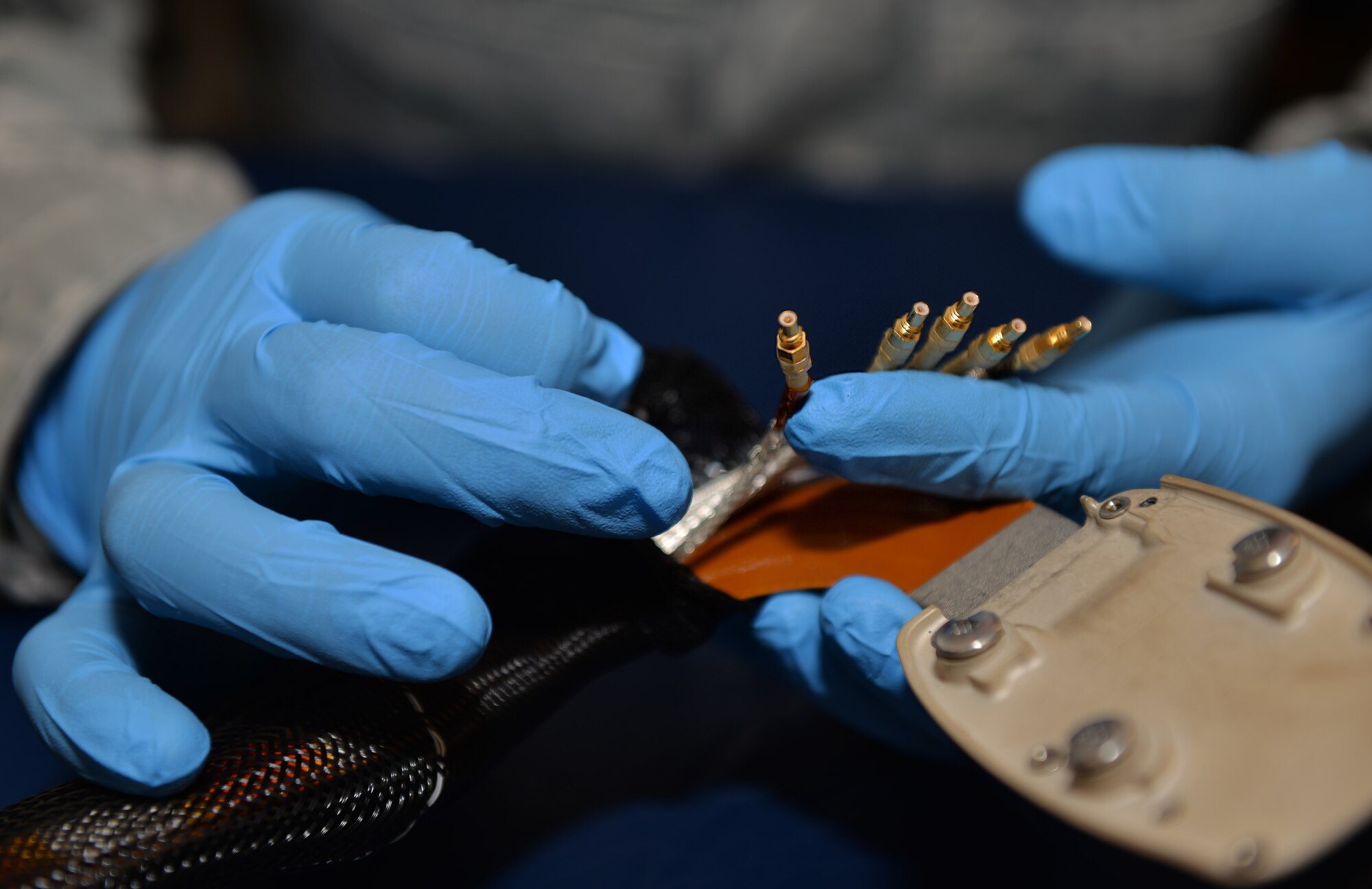 Staff Sgt. Edwin Portan, 33rd Operations Support Squadron aircrew flight equipment NCO in charge, inspects the coaxial cable on a helmet mounted display at Eglin Air Force Base, Fla., Feb. 29, 2016. These cables plug into the F-35A Lightning II to sync the helmet with the jet, giving the pilot access to various flight information such as airspeed, heading, altitude, targeting information and aircraft status. (U.S. Air Force photo/Senior Airman Andrea Posey)