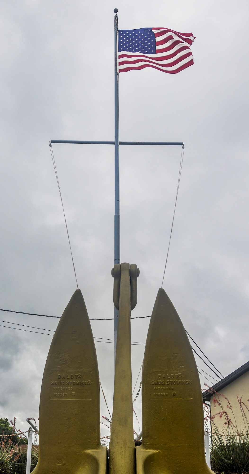 The original brass ship plates of the technical research ship USS Liberty ARTG-5 stand underneath the flag at the Liberty Memorial Park on Goodfellow Air Force Base, Texas, June 3, 2016. The park was dedicated in 2003 then expanded and renovated in 2004. (U.S. Air Force photo by 2nd Lt Tisha Wilkerson/Released)