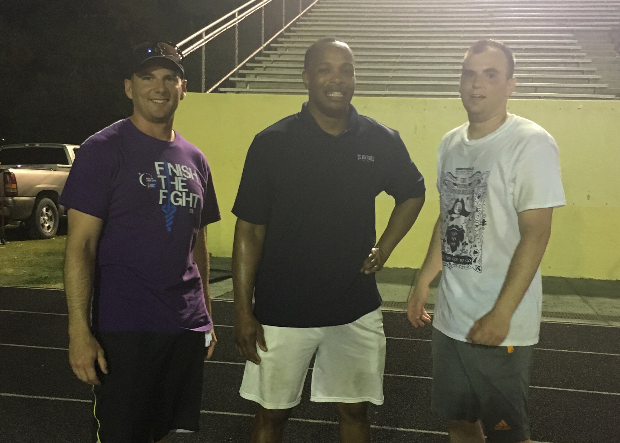 Staff Sgts. Jordan Fuller, left, and Joshua Henry, right, 325th Force Support Squadron Airman Leadership School instructors, and Master Sgt. Derrick Bennett, 325th FSS ALS commandant, pose for a photo after the Relay For Life of Greater Panama City, April 30 at Tommy Oliver Stadium, Panama City, Fla. The Airmen decided to walk the entire event, 12 hours, 31 miles each. (Courtesy Photo)
