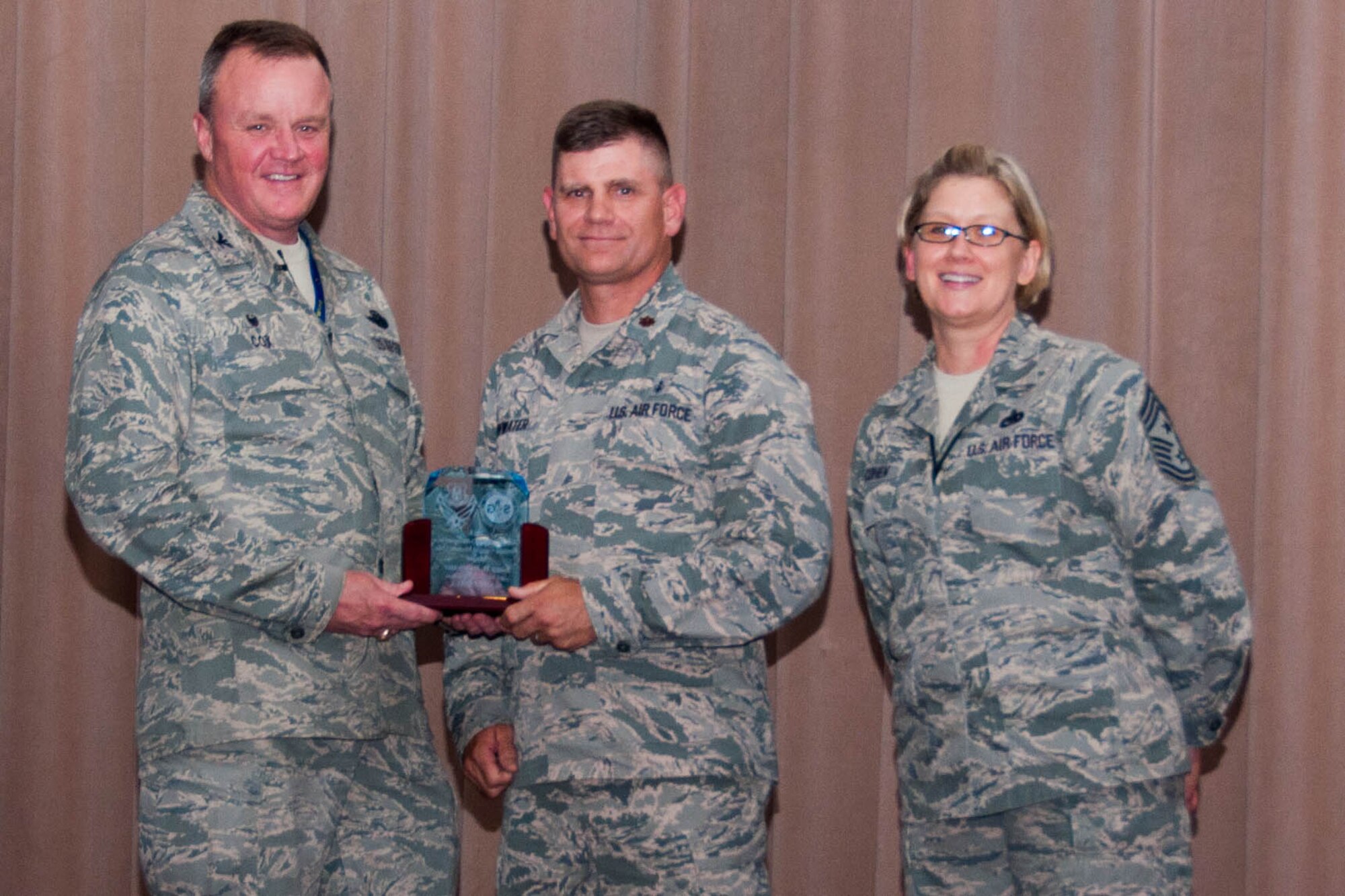 U.S. Air Force Major Gary Rainwater, 307th Medical Squadron, is awarded the 2015 Outstanding Field Grade Officer assigned to a Reserve Ground Medical Unit during Commander’s Call on Barksdale Air Force Base, La., June 5, 2016.  Rainwater received a plaque presented by the 307th Bomb Wing Commander, Col. Bruce Cox, and for the 307th Bomb Wing Command Chief, Chief Master Sgt. Shelley Cohen. (U.S. Air Force photo by Master Sgt. Laura Siebert/Released)