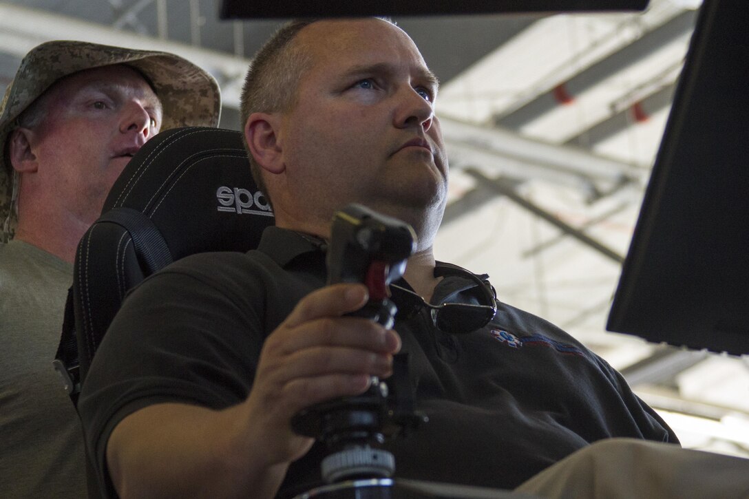 Timothy Donovan is the first of the 39 educators to soar into a flight simulator during the 2016 Key Leaders and Educators Workshop aboard Marine Corps Base Quantico, Va., June 8.  Educators from states east of the Mississippi River visited Marine Helicopter Squadron 1 during the aviation portion of their visit. While at HMX-1, the educators were briefed on flight operations, flew in a MV-22 Osprey and toured the squadron’s hangar.  Donovan is a paramedic instructor for the National Medical Education and Training Center in Bridgewater, Mass.