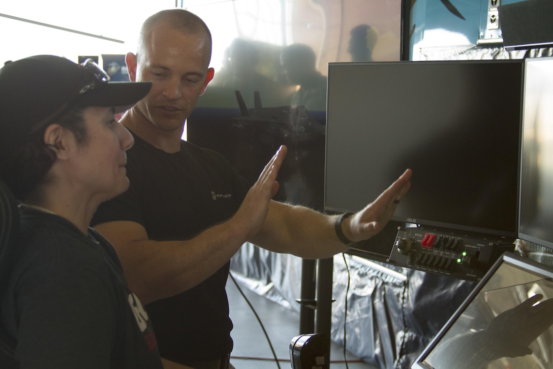 A Marine shows Dariela Rodriguez how to operate a flight simulator during the 2016 Key Leaders and Educators Workshop at Marine Helicopter Squadron One aboard Marine Corps Base Quantico, Va., June 8. Thirty-nine educators from states east of the Mississippi River were briefed on flight operations, flew in a MV-22 Osprey and toured the squadron’s hangar during the aviation portion of their visit. Educators and the Corps build mutually beneficial and meaningful relationships though workshops where educators can better guide students interested in becoming Marine officers. Rodriguez is an assistant professor for Ashland University, Ashland, Oh.
