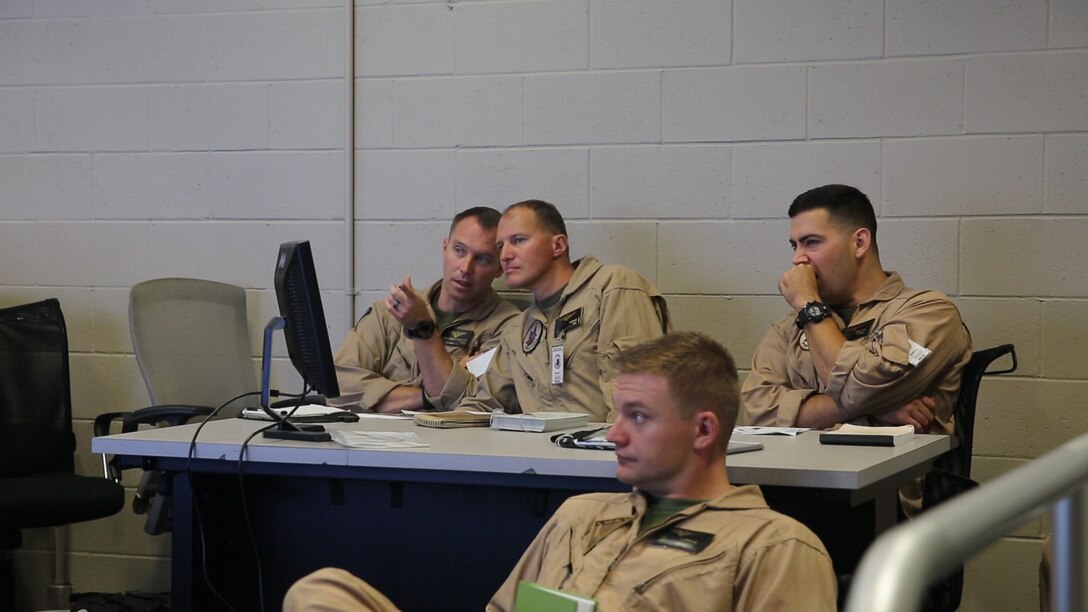 Pilots with Marine Medium Tiltrotor Squadron (VMM) 364 receive a briefing during Virtual Flag aboard Marine Corps Air Station Camp Pendleton, Calif., May 18. Virtual Flag is the flagship event for the U.S. Air Force Distributed Missions Operations Center of Excellence (DMOC) and is a quarterly exercise among military branches using various aircraft and mechanized simulators across the country. (U.S. Marine Corps photo by Sgt. Brian Marion/Released)