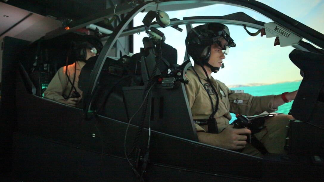 Pilots with Marine Light Attack Helicopter Squadron (HMLA) 169 prepares an AH-1Z Cobra flight simulator for operations during Virtual Flag aboard Marine Corps Air Station Camp Pendleton, Calif., May 18. Virtual Flag is the flagship event for the U.S. Air Force Distributed Missions Operations Center of Excellence (DMOC) and is a quarterly exercise among military branches using various aircraft and mechanized simulators across the country. (U.S. Marine Corps photo by Sgt. Brian Marion/Released)