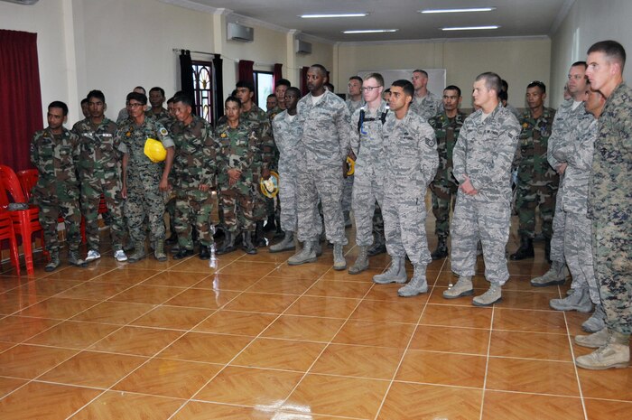 Royal Cambodia Air Forces and U.S. forces gather together Sept 8 for a safety briefing prior to beginning of Pacific Angel 13-5 Cambodia. Sixteen U.S. forces engineers will work alongside 20 Royal Cambodia Armed Forces engineers to renovate three health centers in Takeo. PACANGEL is a joint and combined humanitarian assistance operation held in various countries several times a year and includes medical, dental, optometry, and engineering support programs and various subject-matter expert exchanges. 