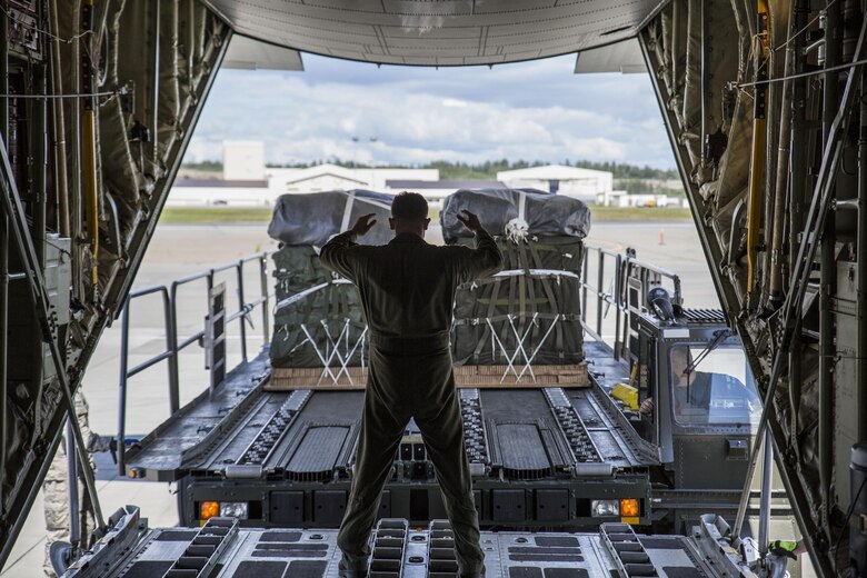 U.S. Marine Corps Lance Cpl. Tony Garcia, a crew chief in-training for Marine Aerial Refueler Transport Squadron 152, from Marine Corps Air Station Iwakuni, Japan, prepares to load cargo onto a KC-130J Super Hercules during exercise Kodiak Mace, May 25, 2016. The squadron utilized cargo from the 4th Infantry Brigade Combat Team, 25th Infantry Division at Joint Base Elmendorf-Richardson, Alaska, in support of exercise Kodiak Mace. Kodiak Mace is an annual joint exercise designed to give the U.S. Marine crew chiefs in-training the opportunity to earn qualifications and eventually the title of crew chief. (U.S. Marine Corps photo by Cpl. Cory Schubert/Released)