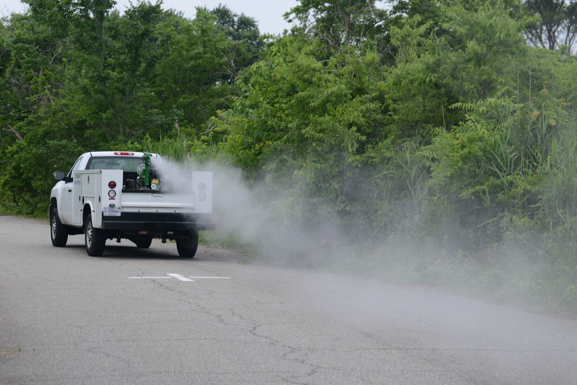 Mitch Burcham, 633rd Civil Engineer Squadron Entomology flight pest controller, drives a truck with a fog machine marked “Contaminated with Pesticides,” to eradicate the mosquito populations at Langley Air Force Base, Va., June 6, 2016. Pest controllers will fog three nights each week from 7 p.m. to approximately 11 p.m., provided the weather permits, through Bethel housing, housing on Langley Air Force Base, followed by the industrial and office buildings across the installation. (U.S. Air Force photo by Staff Sgt. Teresa J. Cleveland)