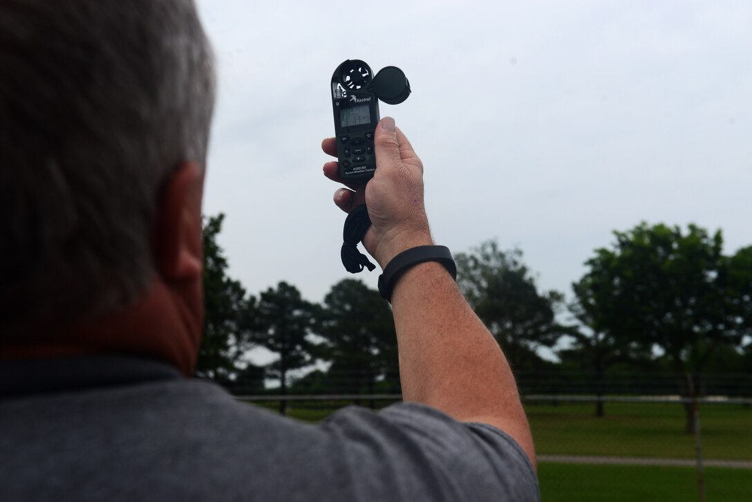 Mitch Burcham, 633rd Civil Engineer Squadron Entomologoy flight pest controller, uses an anemometer to measure wind speeds before fogging pesticides for mosquitos at Langley Air Force Base, Va., June 6, 2016. Wind speeds must be no faster than 10 mph for the pesticides to be effective. (U.S. Air Force photo by Staff Sgt. Teresa J. Cleveland)