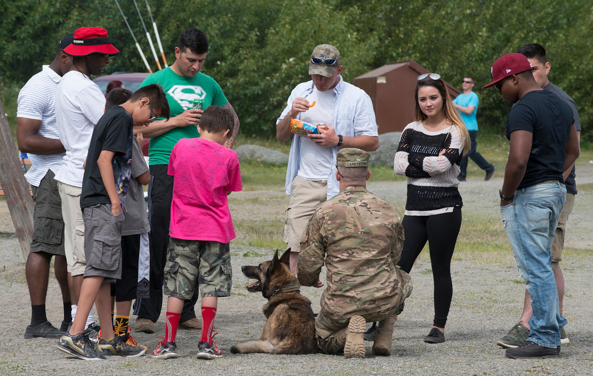 Cpl. Jared Schultz, specialized dog handler with the 549th Military Working Dog Detachment, briefs the crowd on the type of care and discipline that goes into training a military working dog.  Military Police from the 549th MWD Detachment showcased their dogs’ capabilities during 40th Cavalry Regiment, 1st Squadron (Airborne), 25th Infantry Division, 4th Infantry Brigade Combat Team (Airborne) Organization Day at Otter Lake Chalet on June 3.  Representatives from the 549th MWD Detachment executed a variety of commands for their dogs, to include taking down a running offender and how they assist in a traffic stop.  (U.S. Air Force photo by Tech. Sgt. Vernon Cunningham)