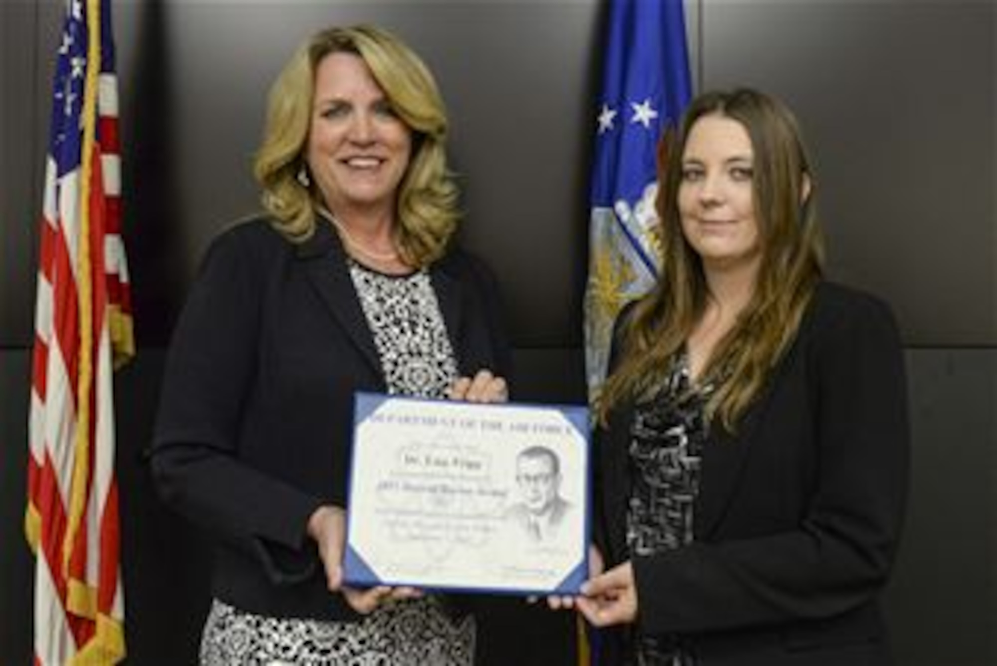 Secretary of the Air Force Deborah James (left) presents the 2015 Harold Brown Award  to Dr. Lisa Tripp during a ceremony June 6 at Wright-Patterson AFB.  The award is for her efforts in creating innovative and cost-saving training methods and platforms for the Air Force intelligence community, and is the highest award given by the Air Force to a scientist or engineer.  (U.S. Air Force photo/Wesley Farnsworth)