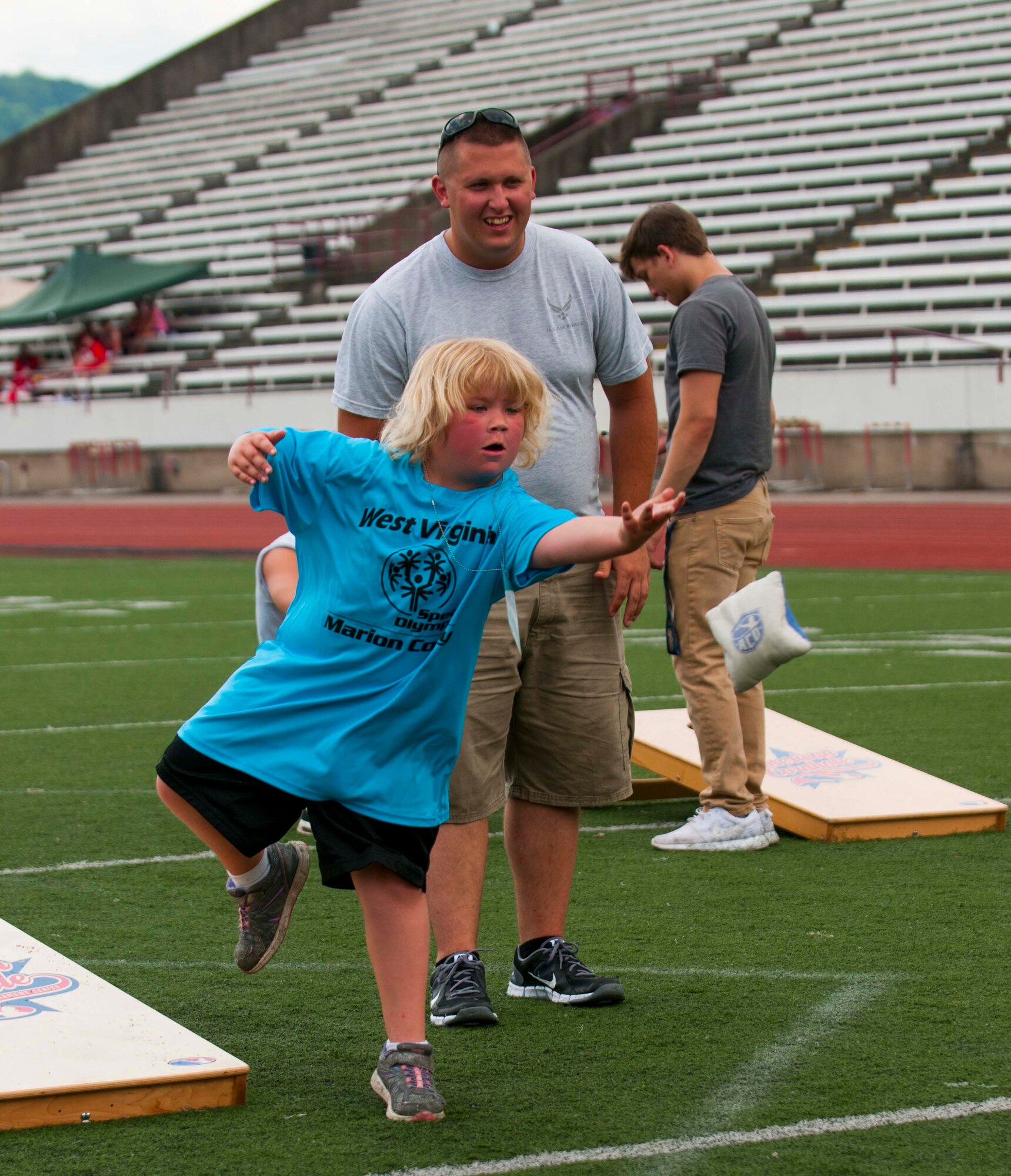 U.S. Air Force Staff Sgt. Channing Jones of the 130th Civil Engineering Squadron, cheers on Cheyenne Filler of Fairmont, W.Va. as she competes in Cornhole, during the 2016 Summer Special Olympics, Saturday, June 4, 2016 at University of Charleston Stadium, Charleston, W.Va. (U.S. Air National Guard Photo by Tech. Sgt. De-Juan Haley)