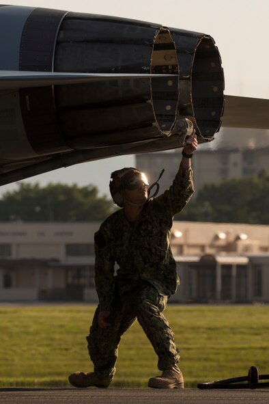 U.S. Navy Petty Officer 1st Class Derek Stevens, Electronic Attack Squadron (VAQ) 138 crew chief, checks an EA-18G Growler’s arresting hook during an annual certification test of an aircraft arresting system at Yokota Air Base, Japan, June 3, 2016. The system went through an annual certification test to ensure its operability following installation by the 374th Civil Engineer Squadron power productions shop. (U.S. Air Force photo by Yasuo Osakabe/Released)