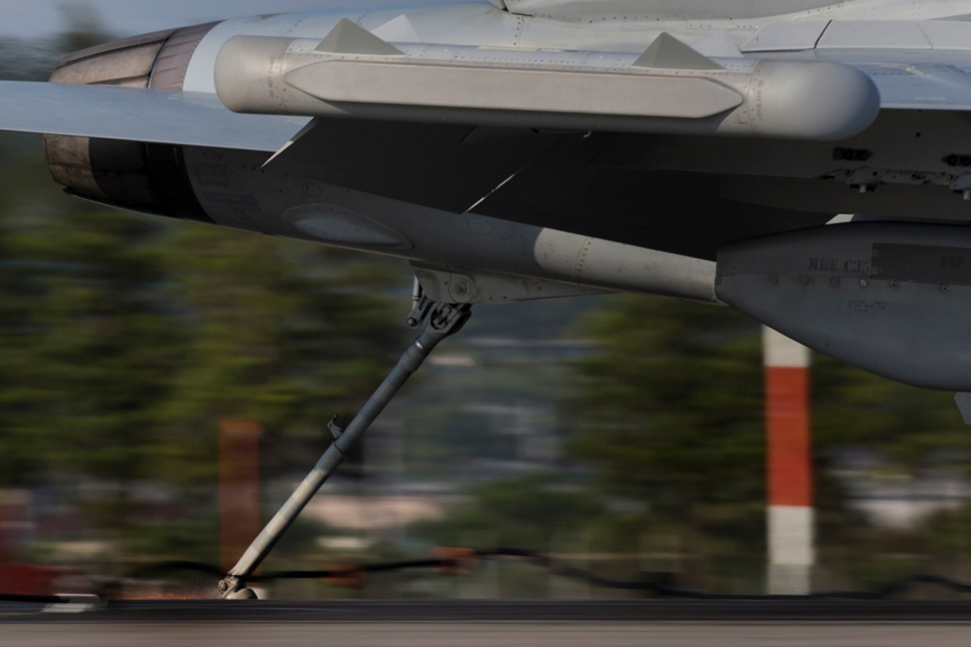 A Navy EA-18G Growler, assigned to the Electronic Attack Squadron (VAQ) 138, engages the aircraft arresting cable at a speed of 150 mph, testing the arresting system, June 3, 2016, at Yokota Air Base, Japan. The 374th Civil Engineer Squadron power productions shop and fire department and the 374th Operations Support Squadron airfield management flight are responsible for testing the arresting system annually. (U.S. Air Force photo by Yasuo Osakabe/Released)  