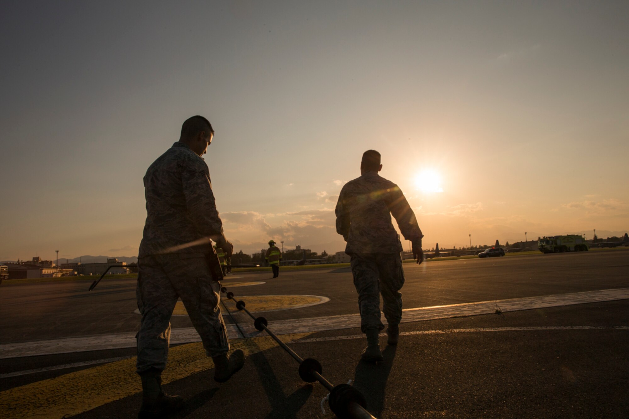 Airmen with the 374th Civil Engineer Squadron electrical power productions shop inspect an emergency aircraft landing cable on the runway at Yokota Air Base, Japan, June 3, 2016. The 374th Civil Engineer Squadron power productions shop, fire department and 374th Operations Support Squadron airfield management flight are responsible for testing the system annually. (U.S. Air Force photo by Yasuo Osakabe/Released)   
