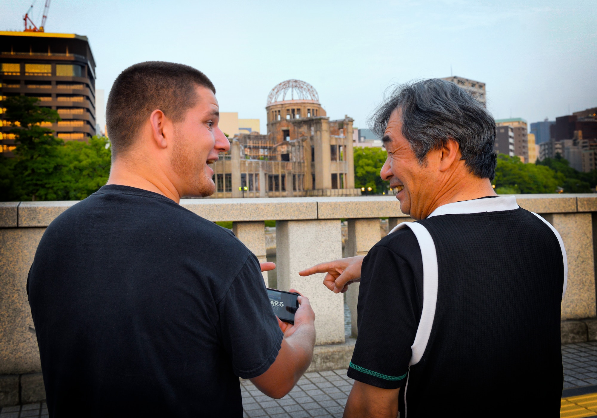 Joseph Galloway, 730th Air Mobility Squadron jet propulsion technician, discusses Japanese drift tracks with Fumio, Nissan 180sx owner, in front of the Hiroshima Peace Memorial at Hiroshima, Japan, May 31, 2016. Despite the fact that there are Japanese living today who experienced World War II, many Japanese and Americans advocate continuing peace and friendship between Japan and the U.S. (U.S. Air Force photo by Airman 1st Class Elizabeth Baker/Released) 