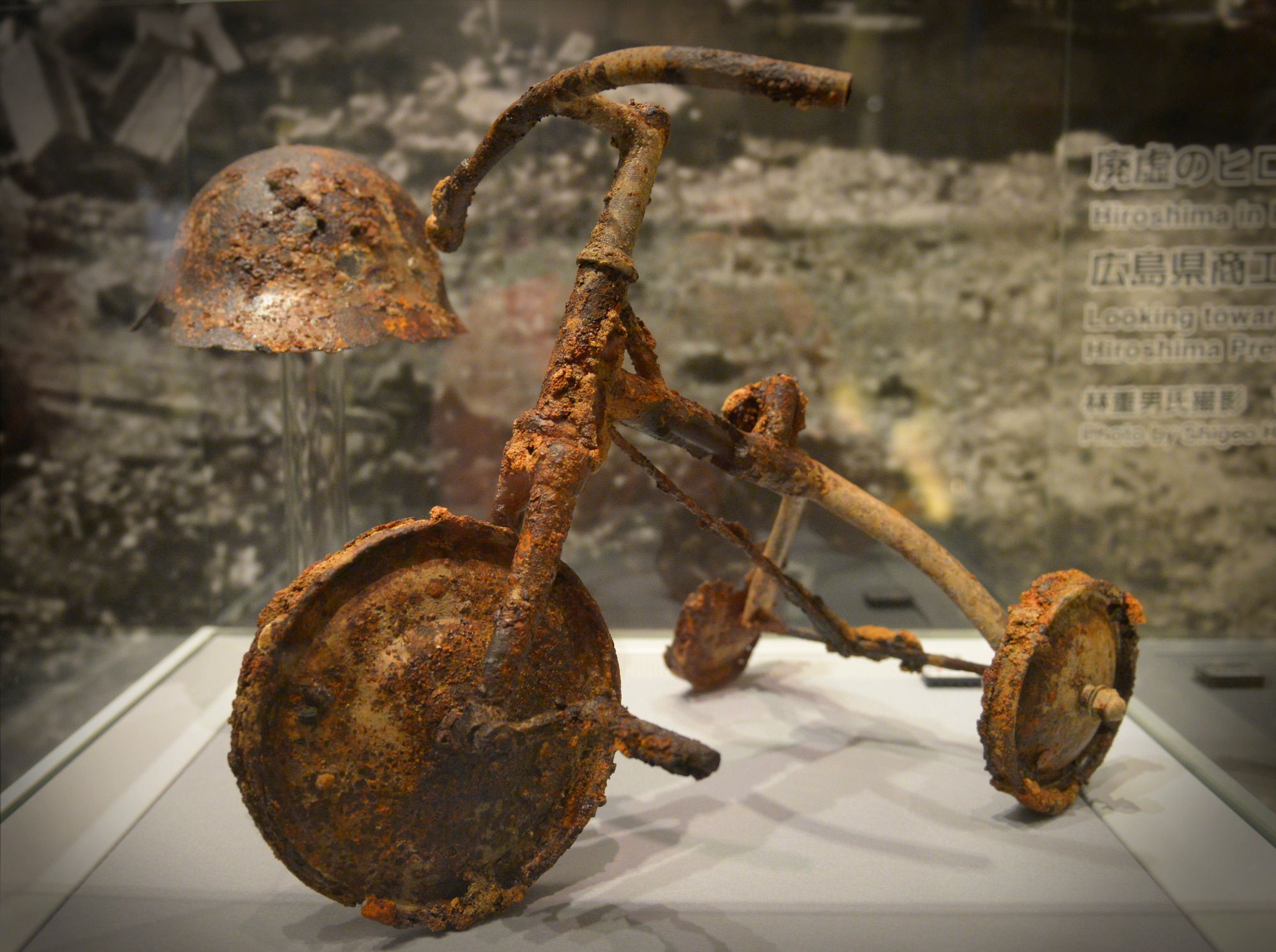 A tricycle and helmet are displayed at Hiroshima Peace Memorial Museum, Hiroshima, Japan, June 1, 2016. Artifacts are among the displays at Hiroshima Peace Memorial Museum, which contains remnants, photos and depictions to demonstrate the destruction of the bomb which the U.S. dropped on Hiroshima at the end of World War II. (U.S. Air Force photo by Airman 1st Class Elizabeth Baker/Released)