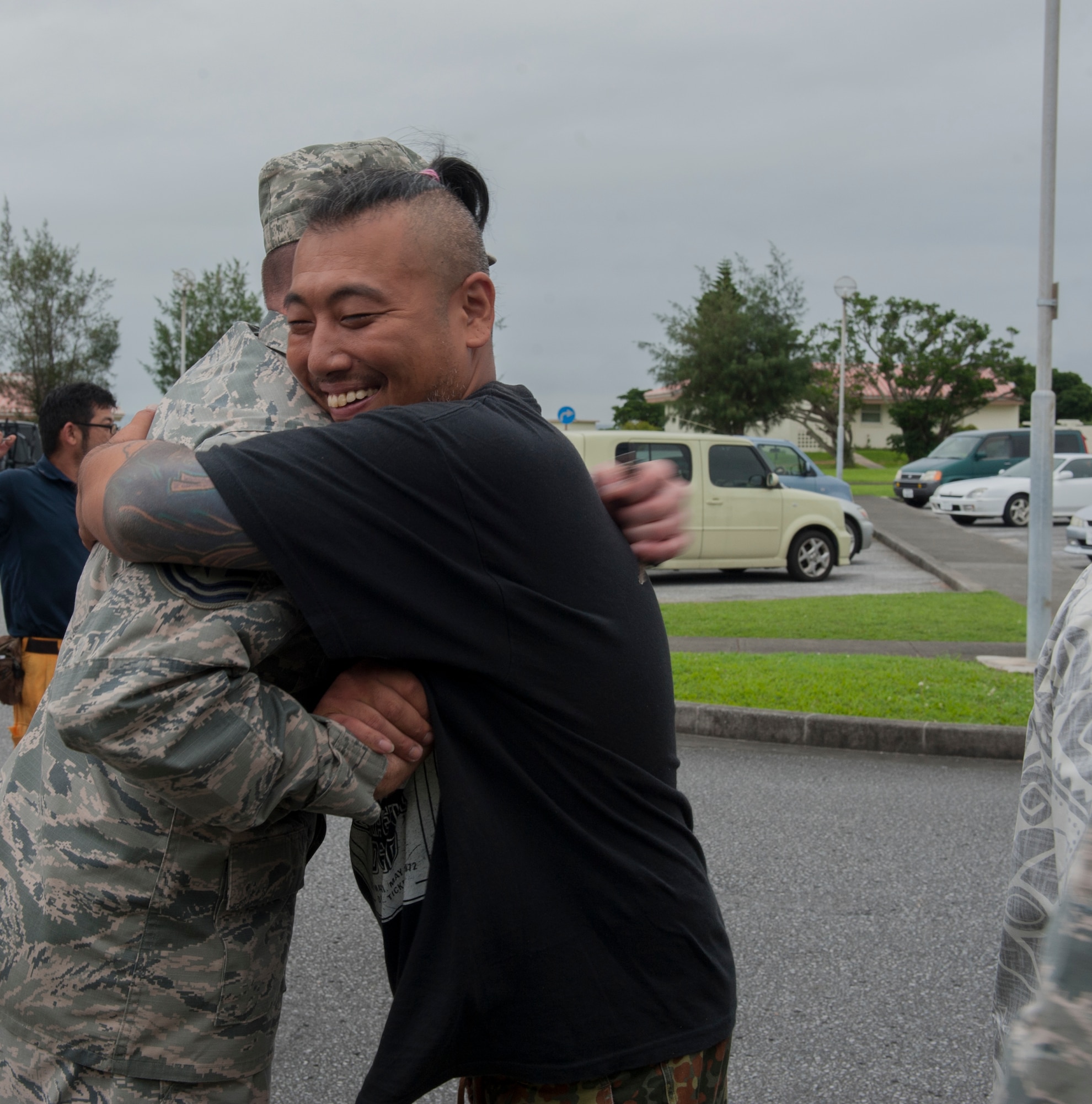 U.S. Air Force Staff Sgt. Jamie Smith, Air Force Sergeants Association Chapter 1553 vice president and 31st Rescue Squadron resource advisor, exchanges a goodbye with Tadasuke Ishimoto, Promise Keepers staff member, June 2, 2016, at Kadena Air Base, Japan. AFSA partnered with Promise Keepers with a clothing drive to donate to the local community. (U.S. Air Force photo by Airman 1st Class Lynette M. Rolen)