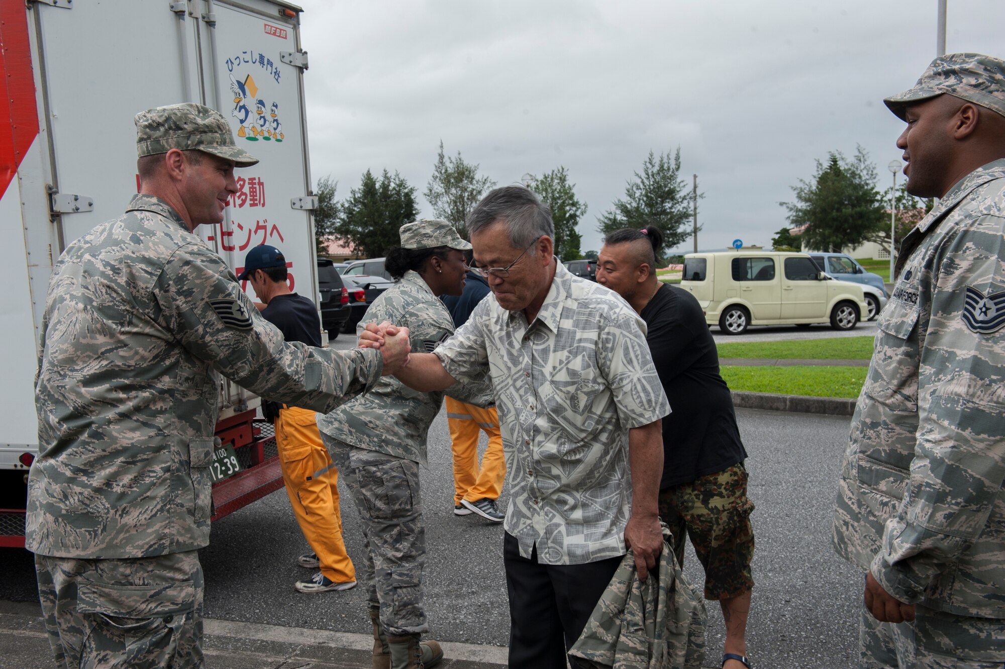 U.S. Air Force Staff Sgt. Jamie Smith, Air Force Sergeants Association Chapter 1553 vice president and 31st Rescue Squadron resource advisor, exchanges a goodbye with Yoshihiko Nishime, pastor of Yugafu Church, after assisting with an outreach project, June 2, 2016, at Kadena Air Base, Japan. Yugafu Church partners with Promise Keepers, a local non-profit organization, in caring for the homeless and needy in the surrounding community. (U.S. Air Force photo by Airman 1st Class Lynette M. Rolen) 
