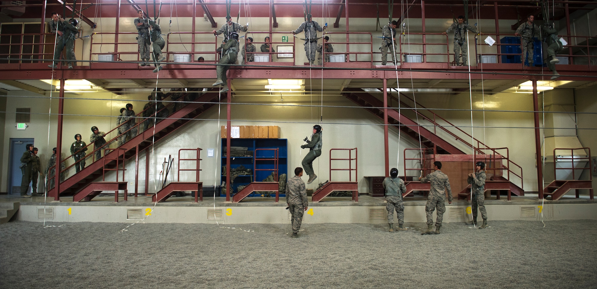 Survival, Evasion, Resistance and Escape specialists help students from across the Air Force learn how to use a personnel lowering device during the hands on portion of the emergency parachute training course May 26, 2016, at Fairchild Air Force Base, Wash. The training starts in a classroom where SERE specialists go over how parachutes function, how to inspect equipment, how to put a parachute on, how to do corrective function procedures and other important hands on information. (U.S. Air Force photo/Airmen 1st Class Sean Campbell)
